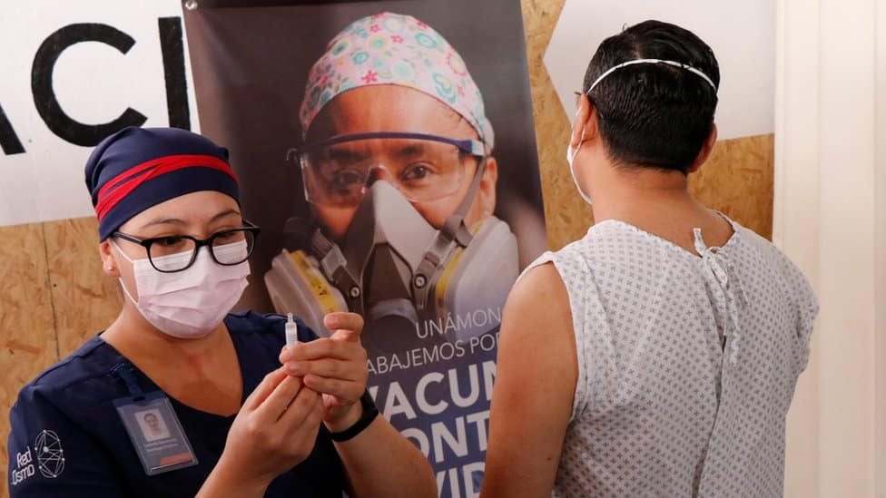 A nurse administers a vaccine