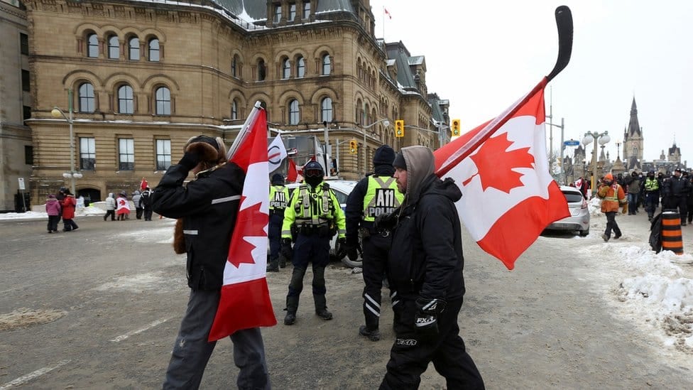 Police officers keep a watchful eye on protesters in Ottawa, 6 February
